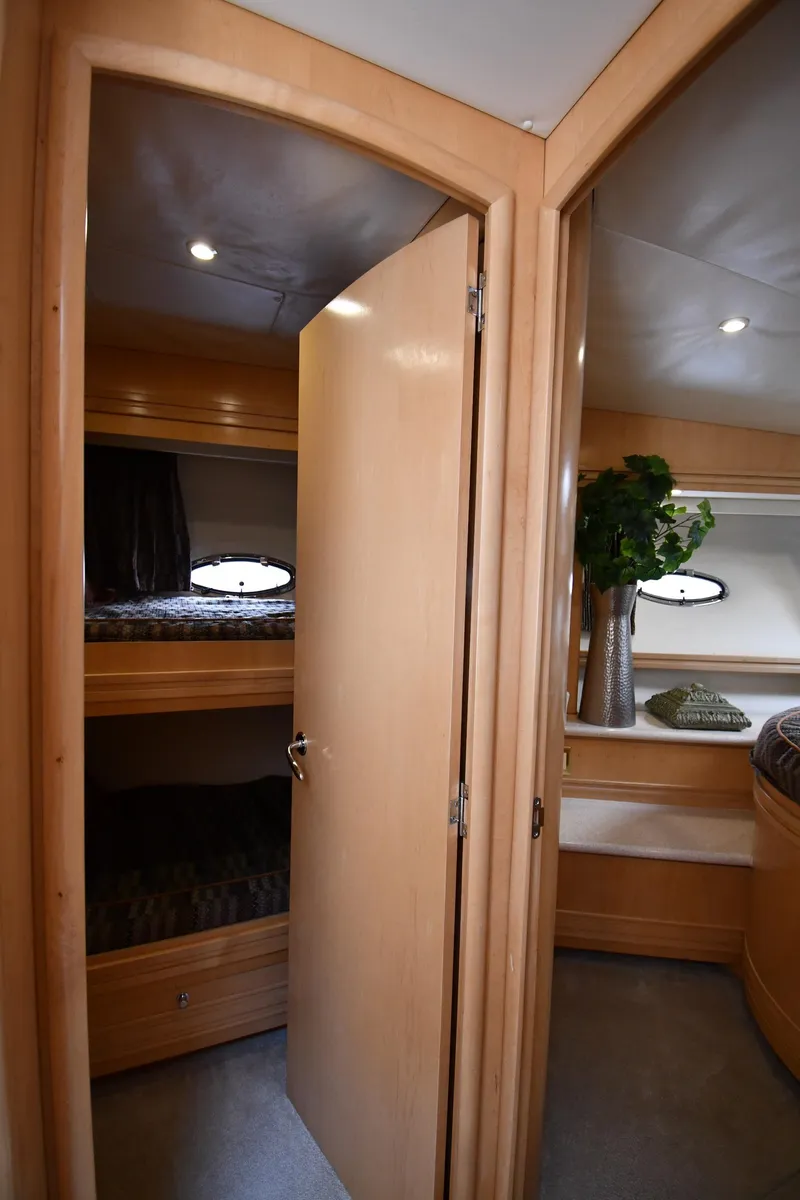 Slide: The Image of 1998 Carver 530 Voyager Pilothouse interior with wooden doors and cozy cabin space. - 49
