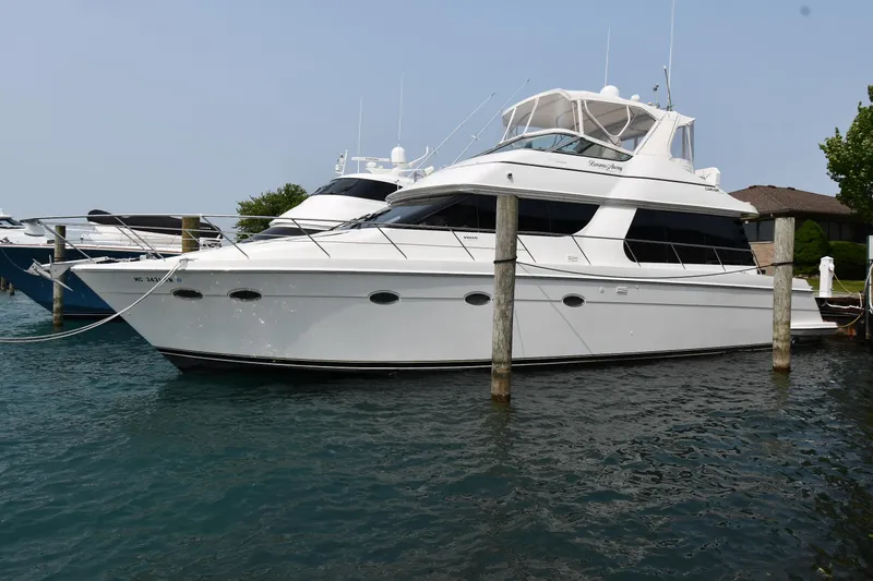 The Image of 1998 Carver 530 Voyager Pilothouse yacht docked in marina, side view. - 0