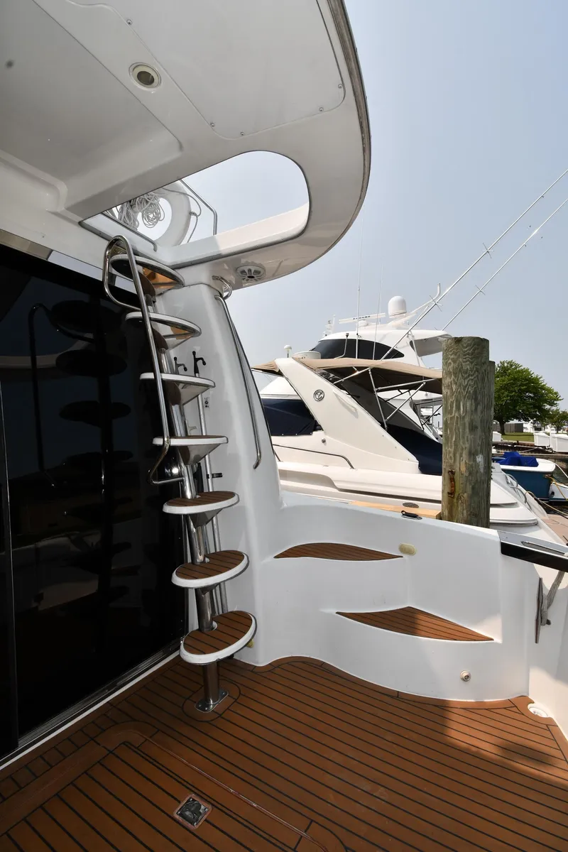 Slide: The Image of 1998 Carver 530 Voyager Pilothouse yacht with spiral staircase and wooden deck. - 13