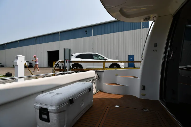 Slide: The Image of 1998 Carver 530 Voyager Pilothouse docked near a warehouse with a parked SUV. - 16