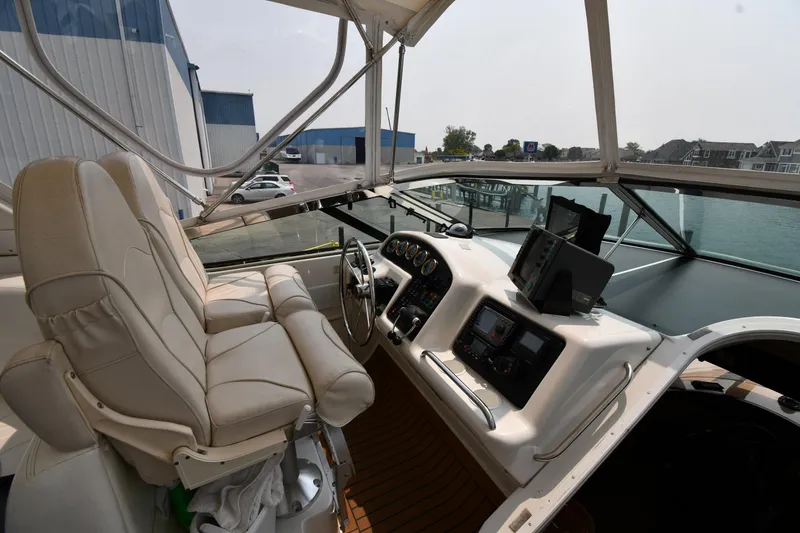 Slide: The Image of 1998 Carver 530 Voyager Pilothouse interior with helm, leather seat, and navigation equipment. - 19