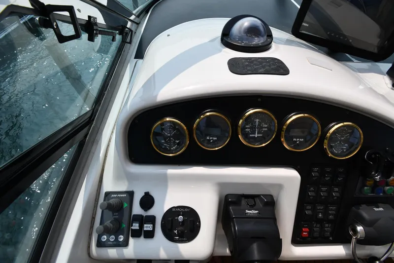 Slide: The Image of 1998 Carver 530 Voyager Pilothouse dashboard with gauges and controls. - 23