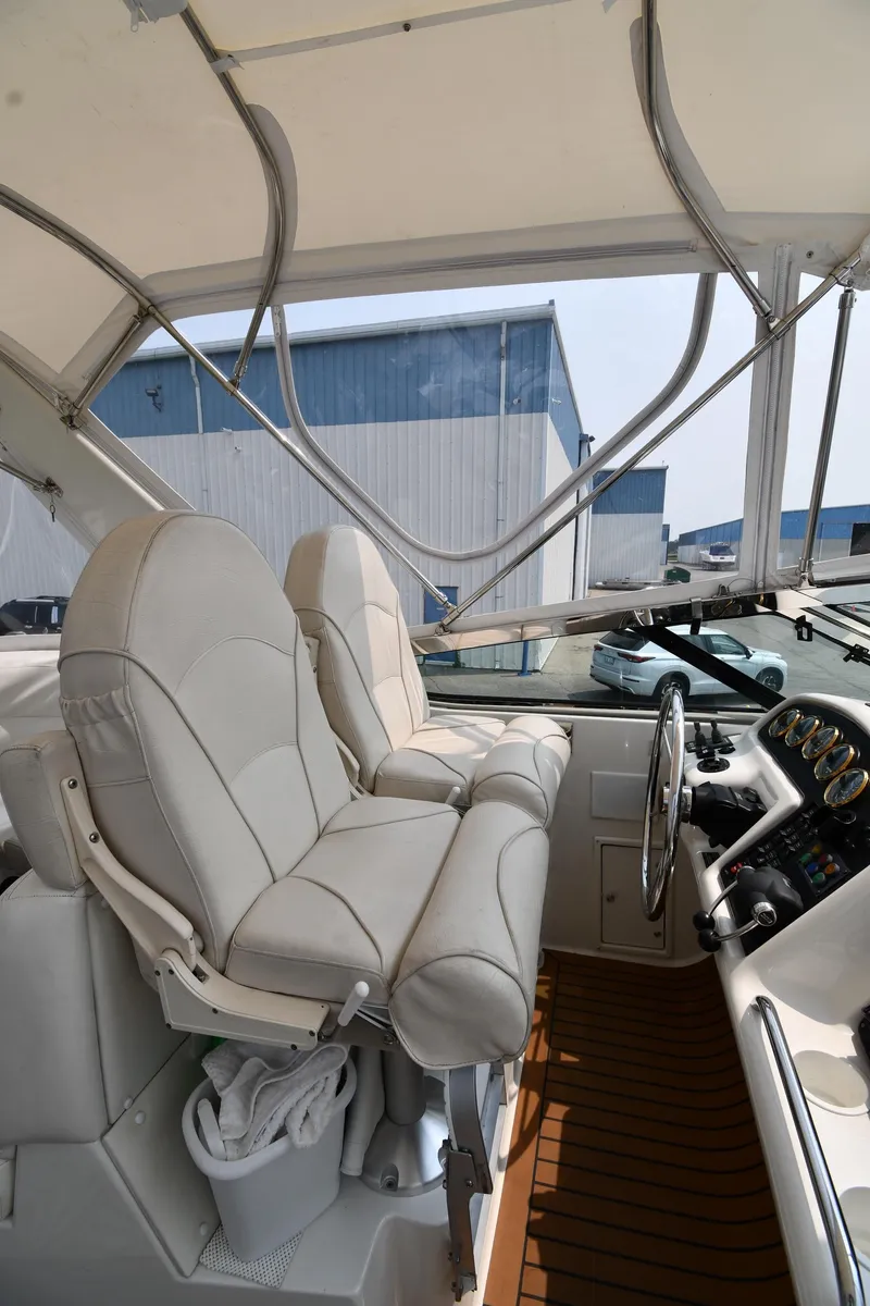 Slide: The Image of 1998 Carver 530 Voyager Pilothouse interior with white leather seats and steering wheel. - 25