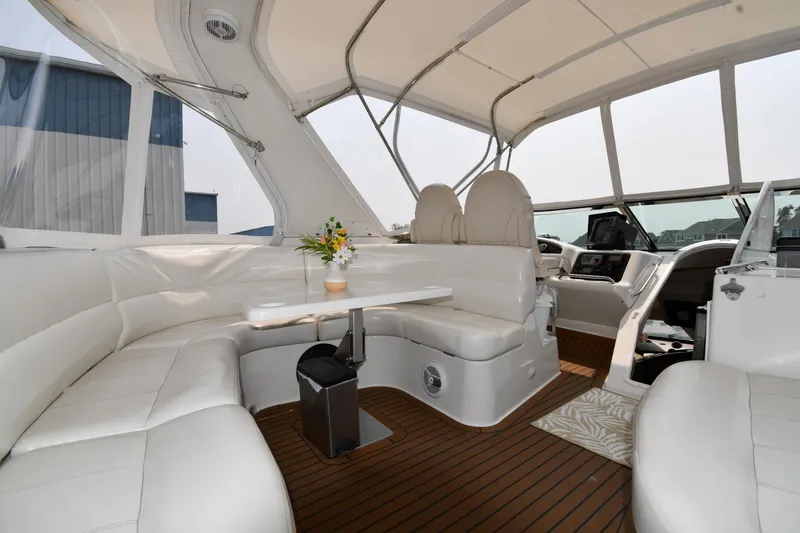 Slide: The Image of Luxurious interior of 1998 Carver 530 Voyager Pilothouse with white seating and wooden flooring. - 28