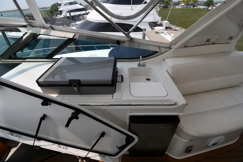 Slide: The Image of 1998 Carver 530 Voyager Pilothouse yacht interior with sink, seating, and storage. - 33
