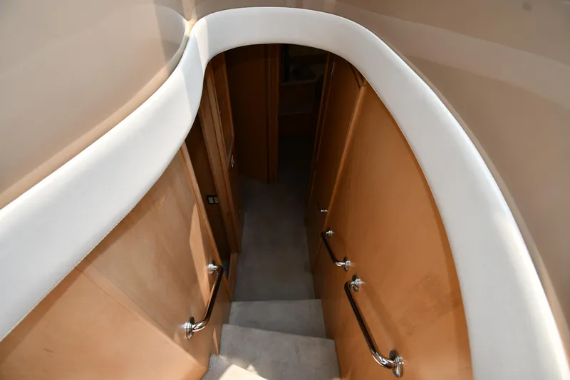 Slide: The Image of Staircase inside 1998 Carver 530 Voyager Pilothouse yacht with wooden handrails. - 36