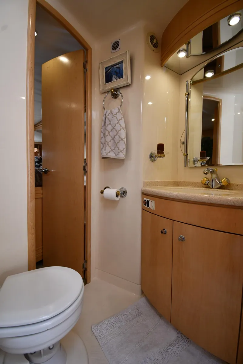 Slide: The Image of Bathroom interior of 1998 Carver 530 Voyager Pilothouse yacht, featuring modern fixtures and wood cabinetry. - 47