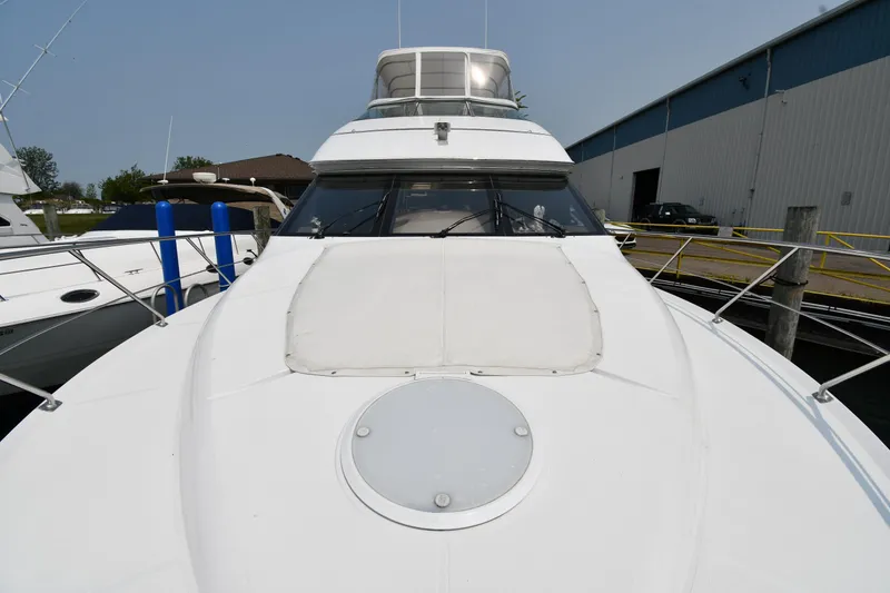 Slide: The Image of 1998 Carver 530 Voyager Pilothouse yacht docked at marina, front view. - 5