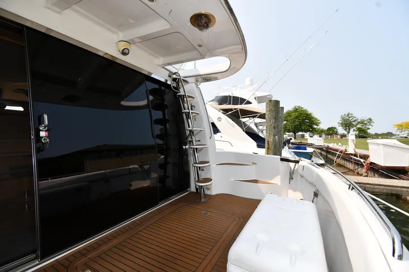 Slide: The Image of 1998 Carver 530 Voyager Pilothouse yacht docked, featuring sleek design and spacious deck area. - 9
