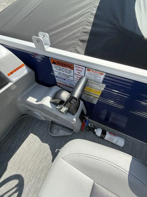 Slide: The Image of Control panel of 2023 Bennington 22 SXSB boat with warning labels and fire extinguisher. - 17