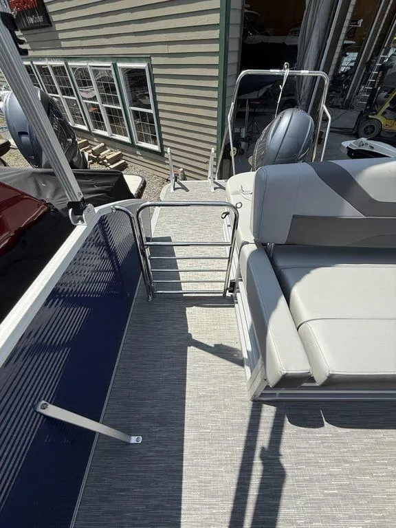 Slide: The Image of 2023 Bennington 22 SXSB pontoon boat interior with seating and railing. - 19