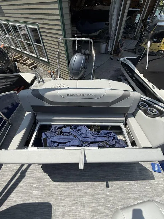 Slide: The Image of 2023 Bennington 22 SXSB boat with open storage compartment on deck. - 21