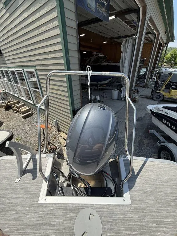 Slide: The Image of 2023 Bennington 22 SXSB boat engine at a marina, with surrounding equipment. - 26