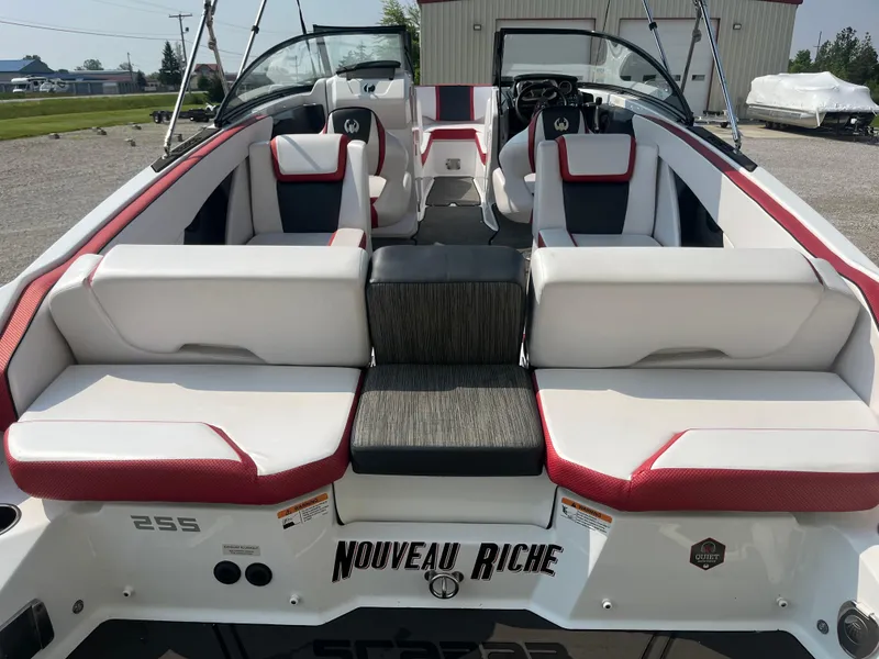 Slide: The Image of 2021 Scarab 255 ID boat with white and red seating, rear view. - 11