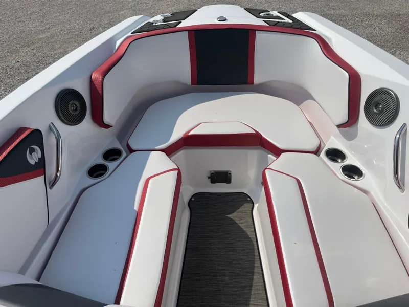 Slide: The Image of 2021 Scarab 255 ID boat interior with red and white seating and cup holders. - 2