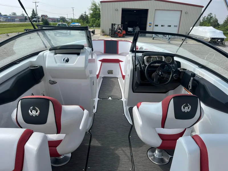 Slide: The Image of 2021 Scarab 255 ID boat interior with red and white seating, steering wheel, and dashboard. - 4