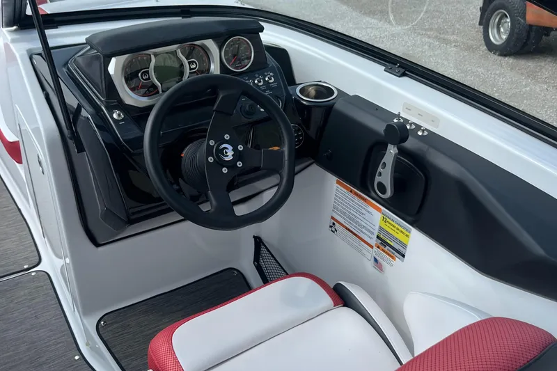Slide: The Image of Interior of 2021 Scarab 255 ID boat with steering wheel and dashboard controls. - 5