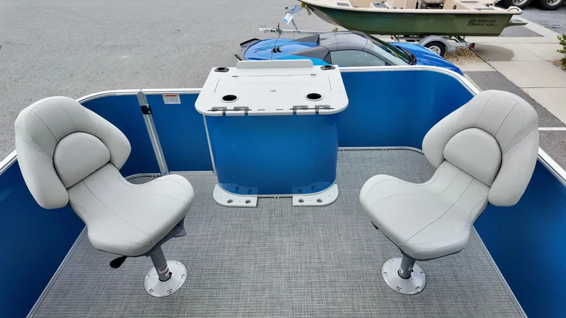 Slide: The Image of 2026 Sylvan Mirage 822 PARTY FISH boat interior with two swivel seats and a blue console. - 10
