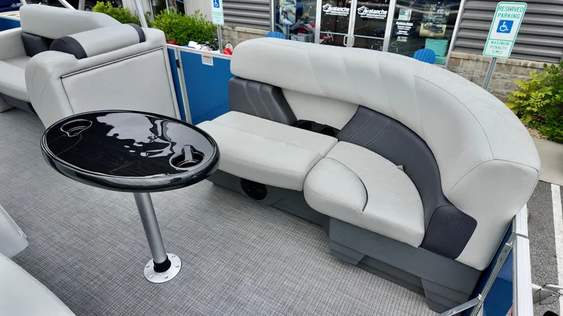 Slide: The Image of 2026 Sylvan Mirage 822 PARTY FISH boat interior with gray seating and black table. - 11
