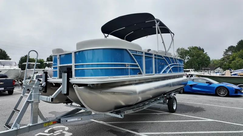 Slide: The Image of 2026 Sylvan Mirage 822 PARTY FISH pontoon boat on trailer in parking lot. - 3