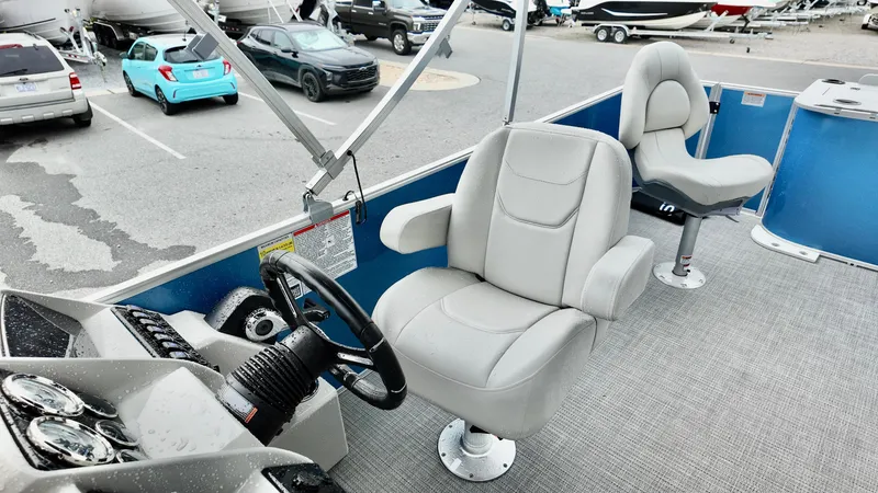Slide: The Image of 2026 Sylvan Mirage 822 PARTY FISH boat interior with steering wheel and seating. - 4