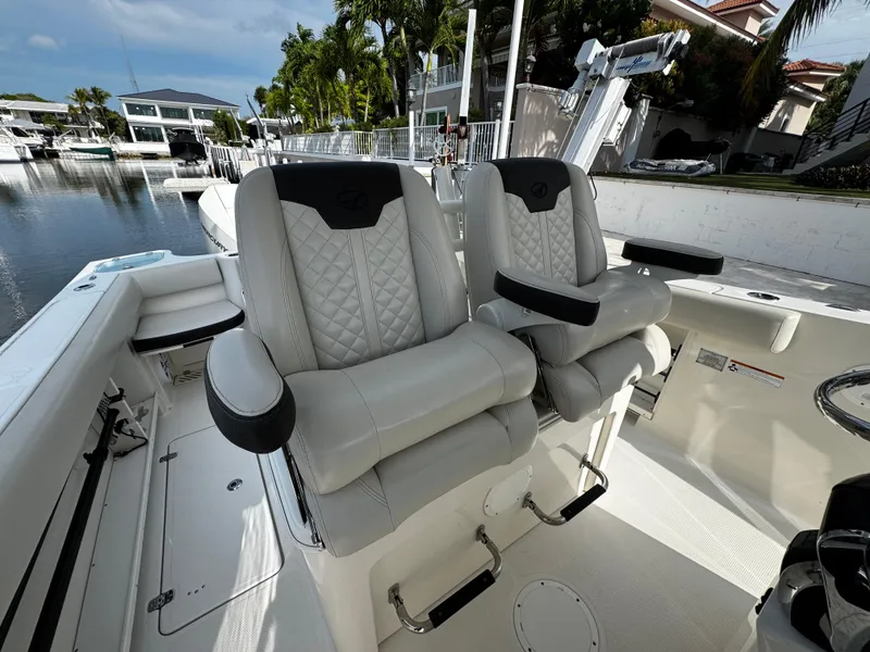 Slide: The Image of Luxury seating on 2022 Sailfish 290 CC boat, docked in a serene marina. - 18