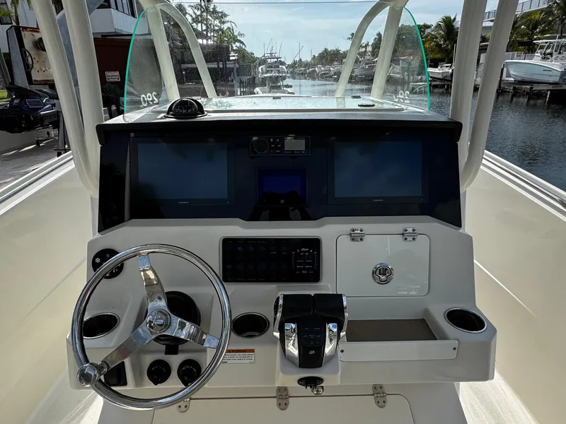 Slide: The Image of Center console of 2022 Sailfish 290 CC boat with steering wheel and navigation screens. - 20