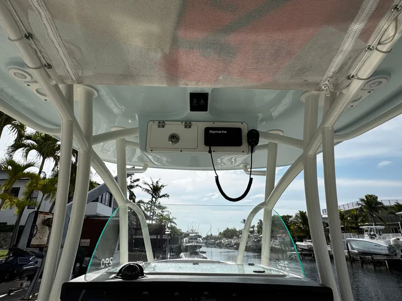 Slide: The Image of 2022 Sailfish 290 CC boat interior view with electronics and canopy. - 22