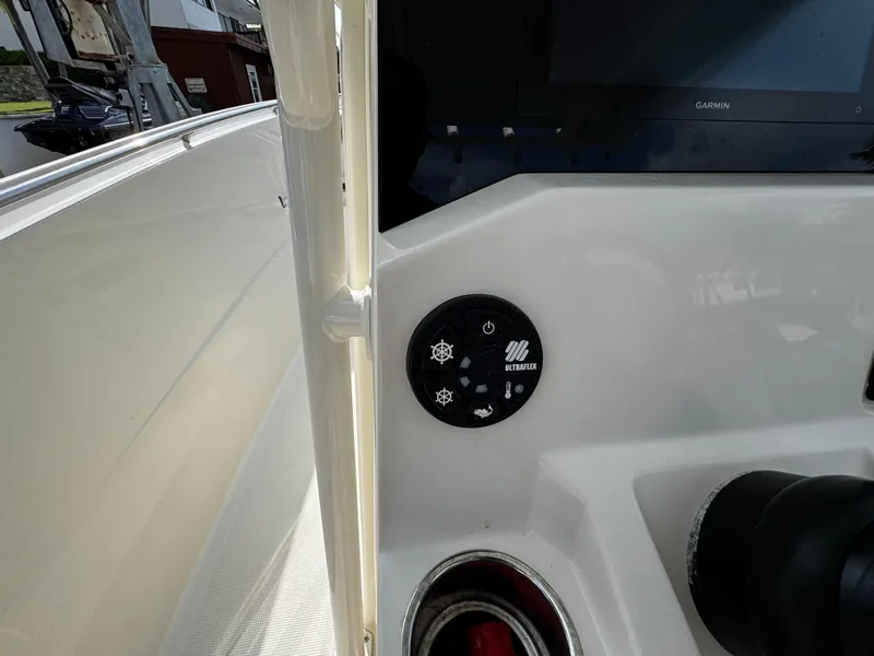 Slide: The Image of Control panel on a 2022 Sailfish 290 CC boat dashboard with various buttons. - 25
