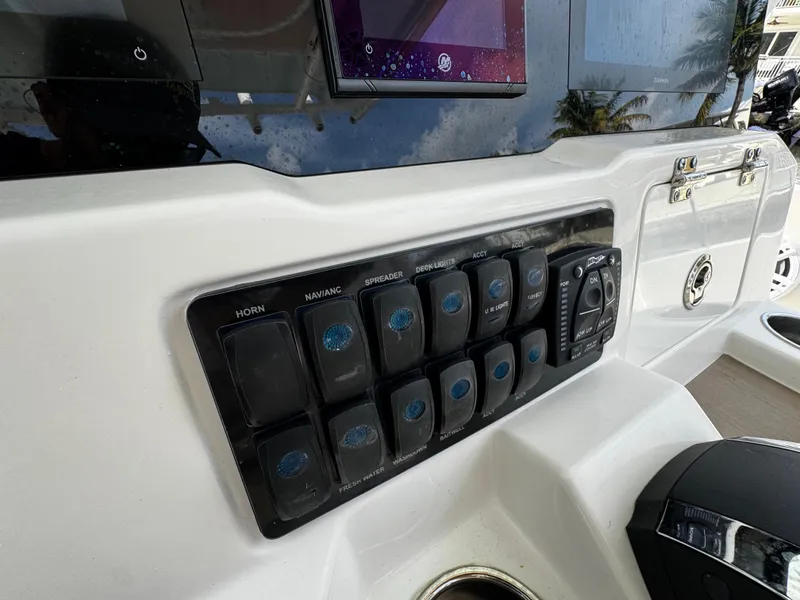 Slide: The Image of Control panel of 2022 Sailfish 290 CC boat with labeled switches and displays. - 27