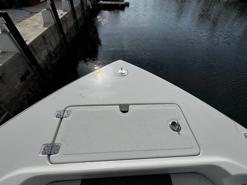 Slide: The Image of Bow of 2022 Sailfish 290 CC boat docked by calm water. - 38
