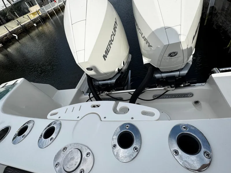 Slide: The Image of 2022 Sailfish 290 CC boat with dual Mercury engines at a dock. - 39