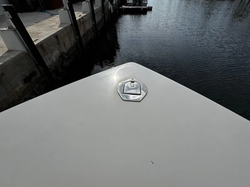 Slide: The Image of Bow of 2022 Sailfish 290 CC boat docked by calm water. - 40
