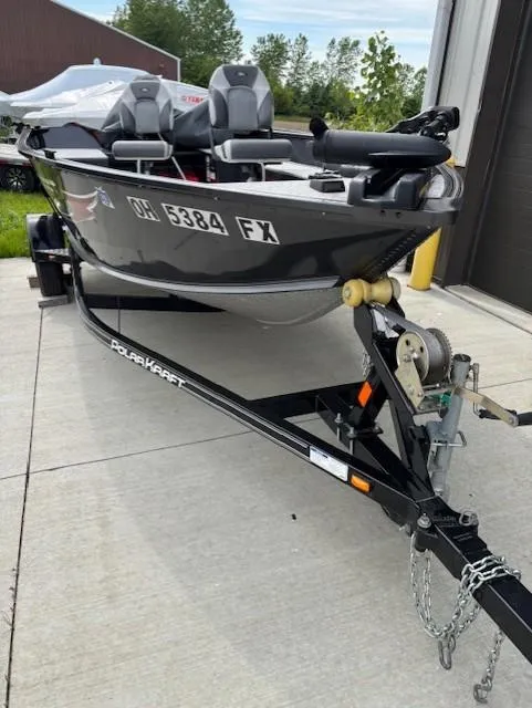 Slide: The Image of 2018 Polar Kraft Outlander 156 SC boat on trailer, parked outdoors. - 4