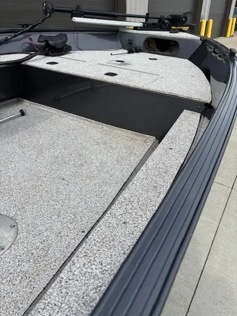 Slide: The Image of 2018 Polar Kraft Outlander 156 SC boat interior with gray deck and storage compartments. - 6