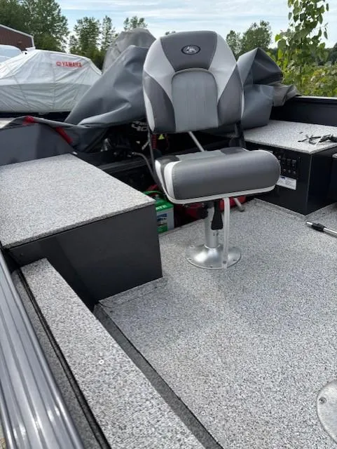 Slide: The Image of 2018 Polar Kraft Outlander 156 SC boat interior with gray seating and carpeted flooring. - 7