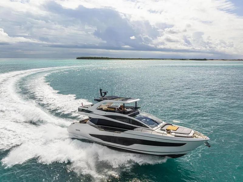 The Image of 2023 Pearl 72 Motor Yacht cruising on turquoise ocean waters. - 0