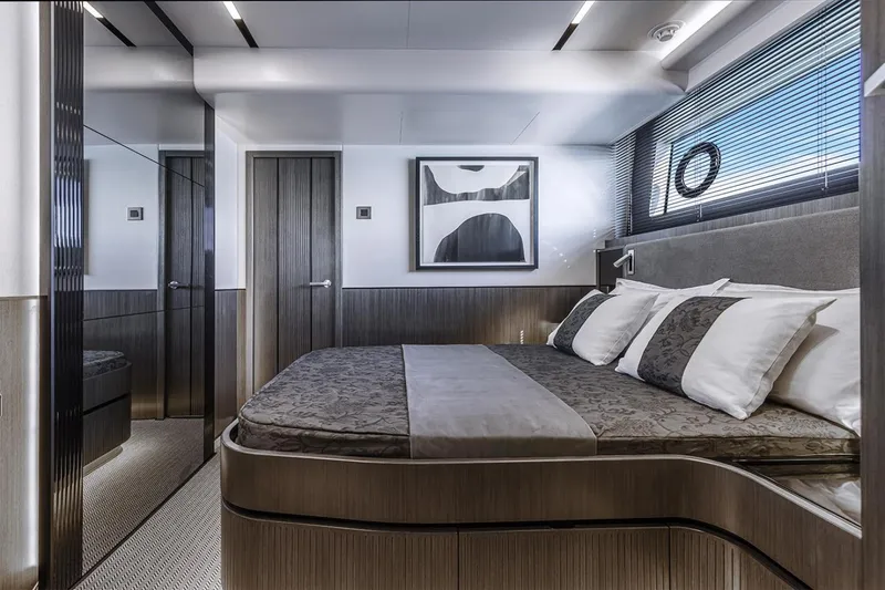 Slide: The Image of Luxurious bedroom interior of 2023 Pearl 72 Motor Yacht with modern decor and elegant bedding. - 6
