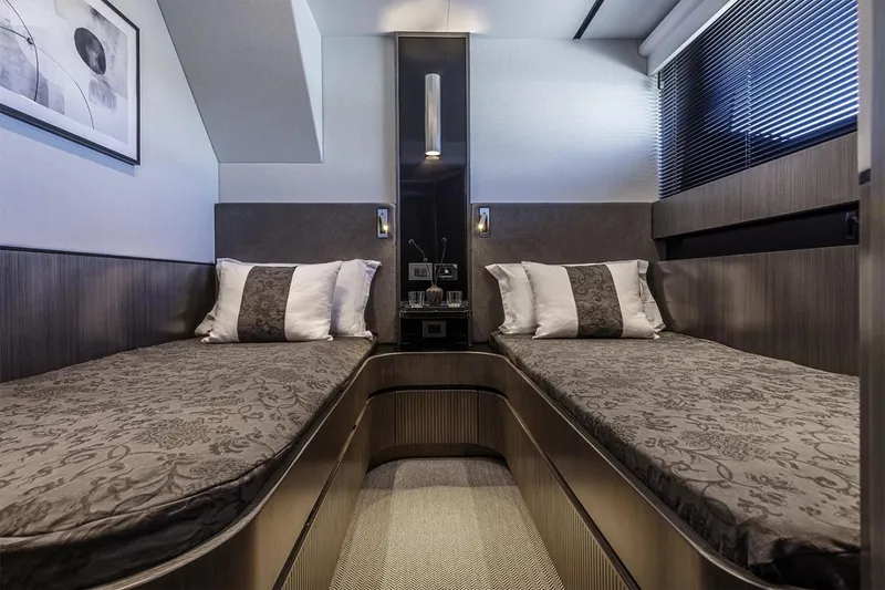 Slide: The Image of Luxurious twin cabin interior of 2023 Pearl 72 Motor Yacht, featuring elegant bedding and modern design. - 8