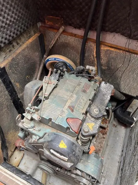 Slide: The Image of Engine compartment of a 2003 Custom 38 C/R boat with visible wear and components. - 11