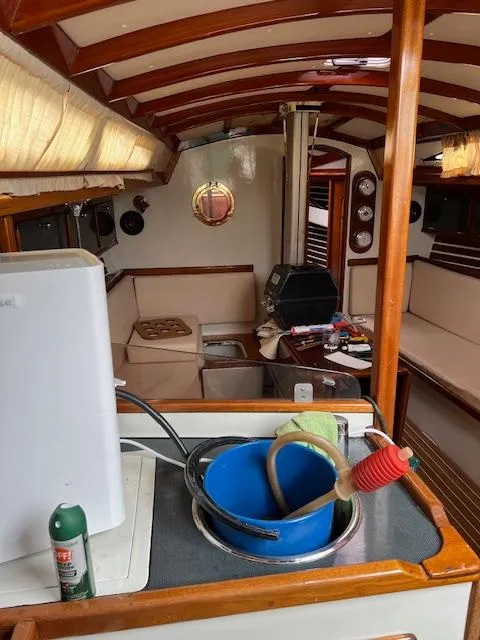 Slide: The Image of Interior of a 2003 Custom 38 C/R boat with wooden accents and cozy seating area. - 12