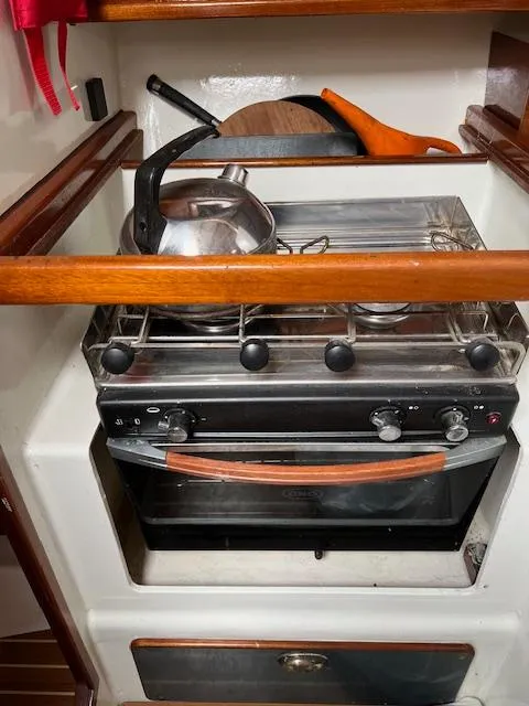 Slide: The Image of Compact kitchen stove with kettle and pan on a Custom 38 C/R boat, 2003 model. - 13