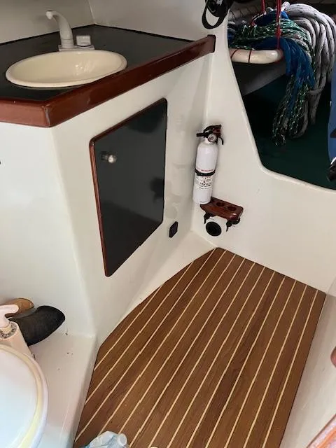 Slide: The Image of Interior of a 2003 Custom 38 C/R boat with sink, fire extinguisher, and striped flooring. - 15