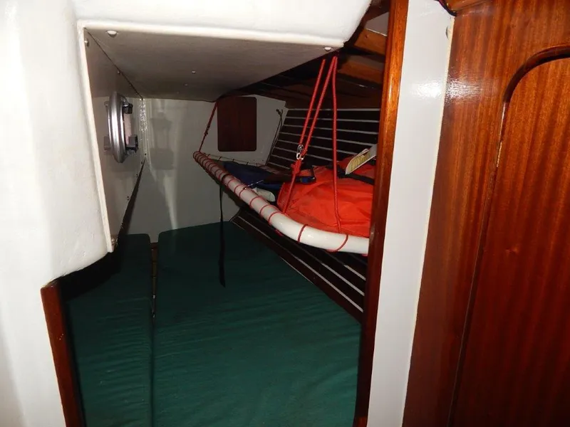 Slide: The Image of Interior cabin of a 2003 Custom 38 C/R boat with hammock and wooden paneling. - 21
