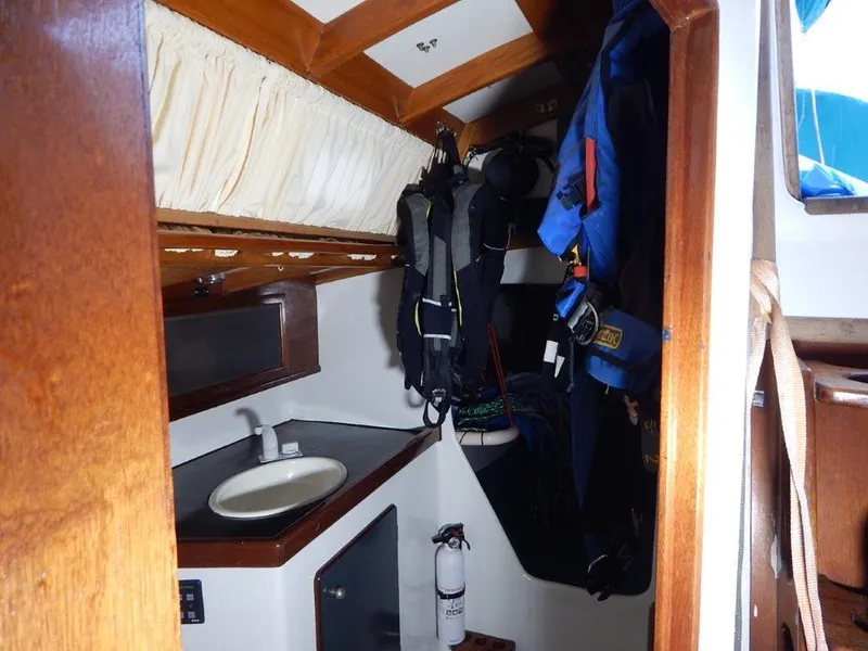Slide: The Image of Interior of 2003 Custom 38 C/R boat with sink, storage, and hanging gear. - 23