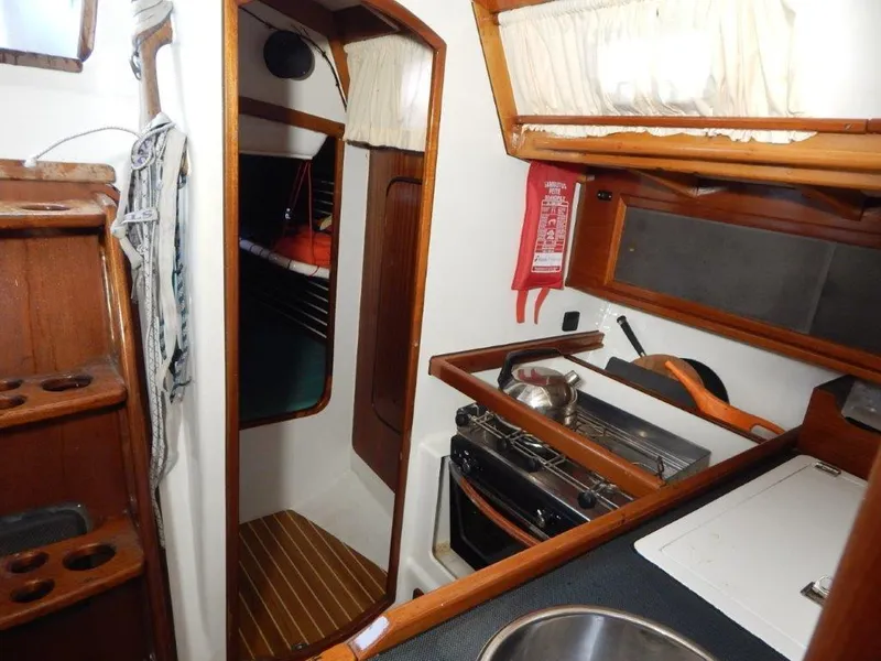 Slide: The Image of Interior of a 2003 Custom 38 C/R sailboat with kitchen and cabin view. - 26