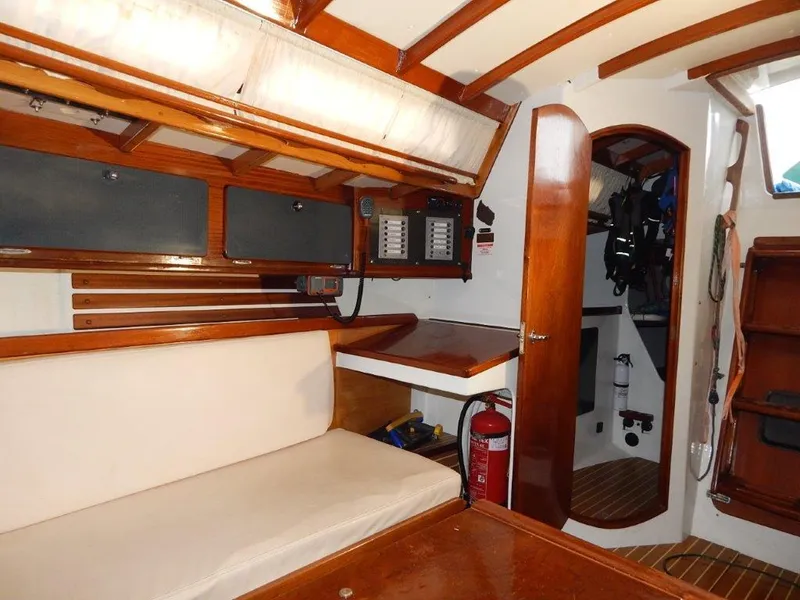 Slide: The Image of Interior of 2003 Custom 38 C/R sailboat with wood finish and seating area. - 27