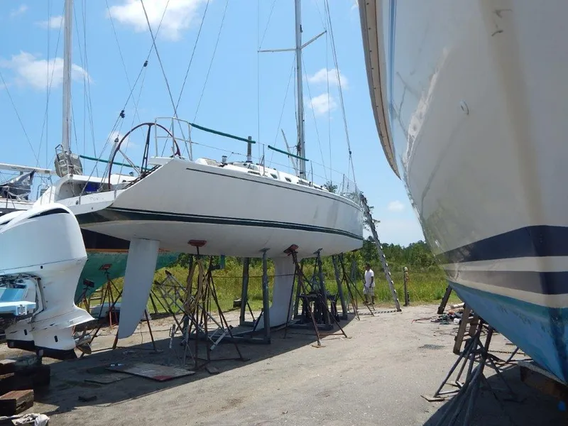 Slide: The Image of Custom 38 C/R sailboat from 2003 on stands in a boatyard under a clear sky. - 3