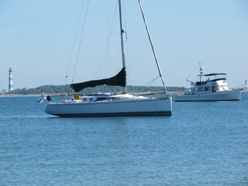 Slide: The Image of Sailboat on calm water with lighthouse in background, Custom 38 C/R, 2003 model. - 31