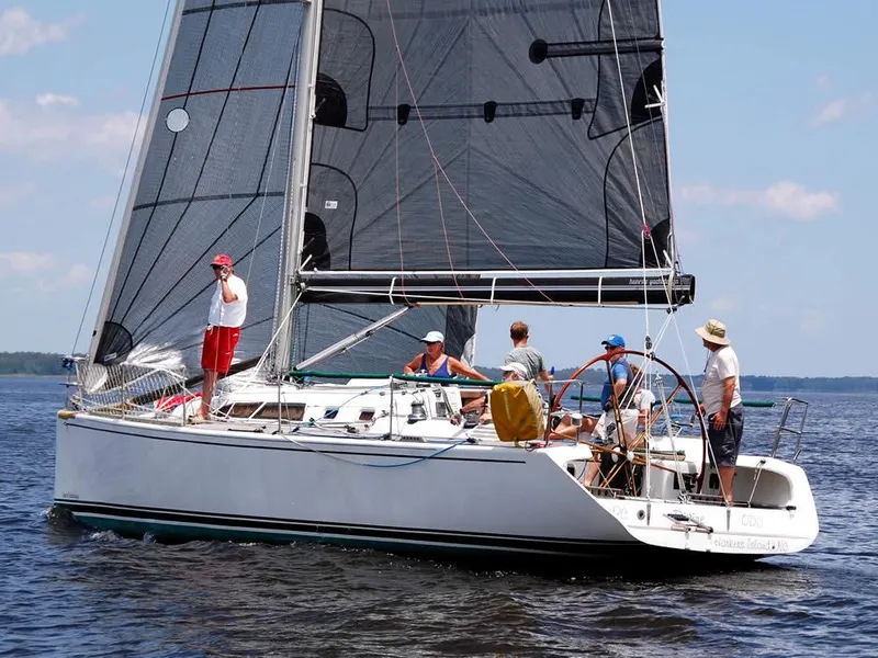 Slide: The Image of Sailboat "Custom 38 C/R" 2003 model with crew on calm water. - 33
